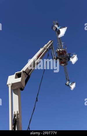 Three spotlights in front of a blue sky, mounted on a working stage, Filmlicht, Duesseldorf, North Rhine-Westphalia, Germany