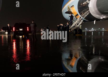 President Donald Trump carries an umbrella as disembark Air Force One during a rain storm upon his arrival to Palm Beach International Airport in West Palm Beach Fla. Friday Jan. 31 2020 and departs en route to Mar-a-Lago. Stock Photo