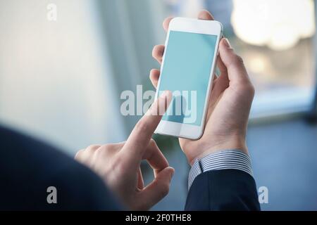 Mock up of a man holding smartphone. Clipping path Stock Photo