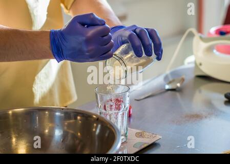 Hand pouring soda into a glass Stock Photo