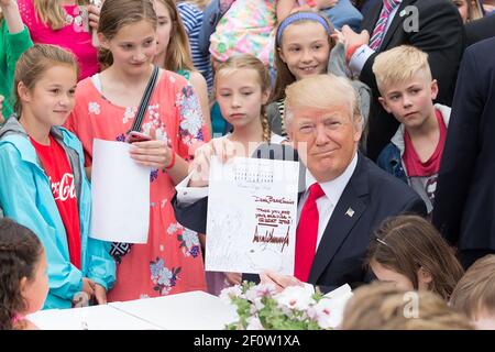 President Donald Trump holds up a signed letter he wrote to a member of the U.S. military on Monday April 17 2017 during the 139th Easter Egg Roll at the White House in Washington D.C. This was the first Easter Egg Roll of the Trump Administration. Stock Photo