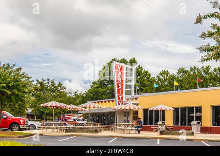 Gwinnett County, Ga / USA - 07 29 20: The Varsity of Gwinnett and a customer eating Stock Photo