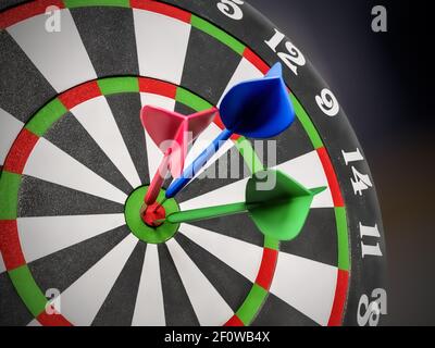 Closeup of dart board with three darts hit in the center Stock Photo