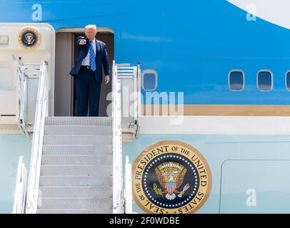 President Donald Trump waves as he disembarks Air Force One at Midland International Air and Space Port in Midland Texas Wednesday July 29 2020 and is greeted by Texas Gov. Greg Abbott former Secretary of Energy Rick Perry Texas Lt.Gov. Dan Patrick Texas Republican Chairman Allen West U.S. Representative candidates and members of the community. Stock Photo