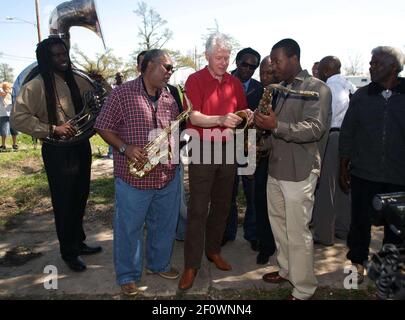 16 March 2008 - New Orleans, Louisiana, Lower 9th ward - Former President Bill Clinton talks saxophones and enjoys a rousing performance by the Lucky 8 Brass Band before he leaves the area. Clinton was in town for the 'Make a Difference, Make a Commitment' clean up of the neighbourhood devastated by Hurricane Katrina. The massive clean up project was organised by Brad Pitt's Make it Right Foundation aided by the Clinton Global Initiative. Photo Credit: Charlie Varley/Sipa Press/pittclintonone.026/0803171349