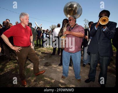 16 March 2008 - New Orleans, Louisiana, Lower 9th ward - Former President Bill Clinton talks saxophones and enjoys a rousing performance by the Lucky 8 Brass Band before he leaves the area. Clinton was in town for the 'Make a Difference, Make a Commitment' clean up of the neighbourhood devastated by Hurricane Katrina. The massive clean up project was organised by Brad Pitt's Make it Right Foundation aided by the Clinton Global Initiative. Photo Credit: Charlie Varley/Sipa Press/pittclintonone.027/0803171350