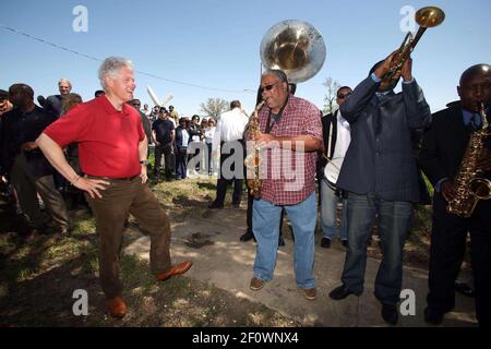 16 March 2008 - New Orleans, Louisiana, Lower 9th ward - Former President Bill Clinton talks saxophones and enjoys a rousing performance by the Lucky 8 Brass Band before he leaves the area. Clinton was in town for the 'Make a Difference, Make a Commitment' clean up of the neighbourhood devastated by Hurricane Katrina. The massive clean up project was organised by Brad Pitt's Make it Right Foundation aided by the Clinton Global Initiative. Photo Credit: Charlie Varley/Sipa Press/pittclintonone.028/0803171350