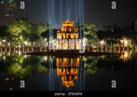 Night view of historical landmark Turtle Tower on Hoan Kiem Lake in central Hanoi, Vietnam. Stock Photo