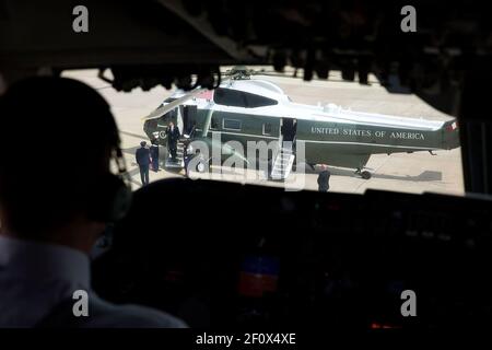 President Barack Obama salutes as he disembarks Marine One, as seen from Air Force One at Joint Base Andrews, Md., April 22, 2014 Stock Photo