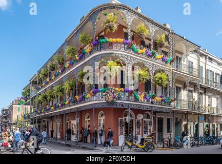 New Orleans Mardi Gras decorations on balconies in the French Quarter, corner of Royal Street and St Peter. Stock Photo