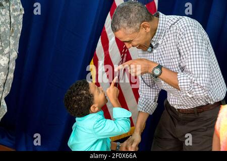 President Barack Obama and a young boy point at each other as the President greets Marine personnel and their families at Marine Corps Base Hawaii on Christmas Day, Dec. 25, 2014 Stock Photo