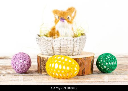 Easter bunny in a basket surrounded by Easter eggs Stock Photo