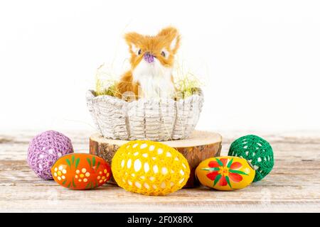 Easter bunny in a basket surrounded by Easter eggs Stock Photo