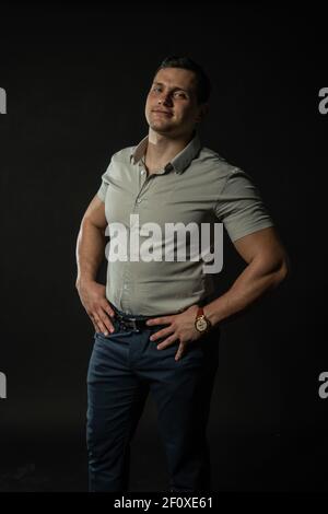 Looks at us hands on the belt male style, portrait lifestyle confidence standing, white trendy boy, shirt cool black Stock Photo