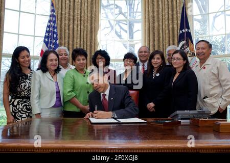 President Barack Obama, surrounded by the family of Cesar Chavez and leaders of the United Farm Workers, signs a proclamation in the Oval Office designating March 31, 2010 as Cesar Chavez Day Stock Photo