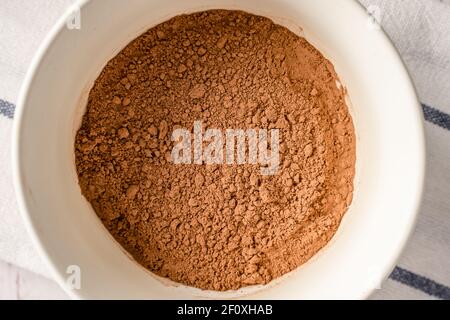 Close up top view on brown cocoa powder in a bowl Stock Photo