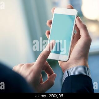 Mock up of a man holding smartphone. Clipping path Stock Photo