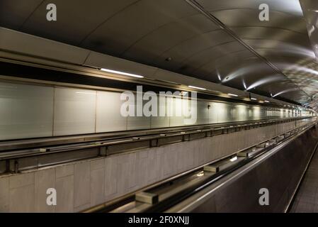 Moving walkway in an empty tunnel of a subway station as abstract background in Naples, Italy Stock Photo