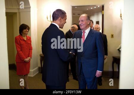 President Barack Obama welcomes King Juan Carlos I of Spain to the Oval Office before their lunch in the Private Dining Room of the White House, Feb. 17, 2010.  At left is Chief of Protocol Capricia Marshall Stock Photo