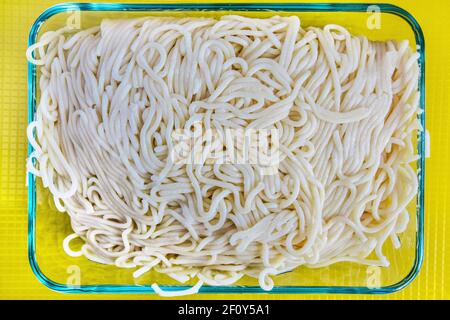 In a glass container the spaghetti is placed for storage or to be served. Stock Photo
