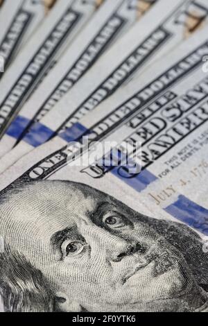 selective focus on fanned out stack of 100 dollar bills with close up on Ben Franklin face Stock Photo