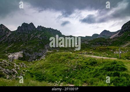 Mangart mountain and road to it covered in clouds, Slovenia Stock Photo