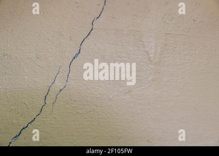 crack on the painted concrete wall. close-up. black and white cracked floor texture Stock Photo