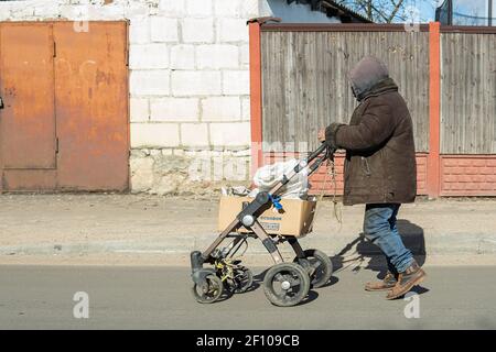 Homeless man walking down the road on a sunny day Stock Photo