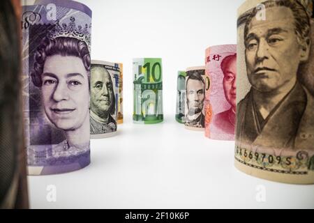 Macro shot of international currency money include US American Dollar, Euro Currency, British UK Pound, Australian Dollar, China Yuan and Japan Yen Stock Photo