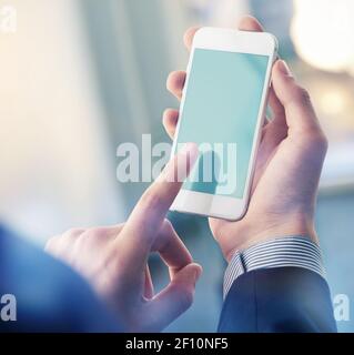 Mock up of a man holding smartphone. Clipping path Stock Photo