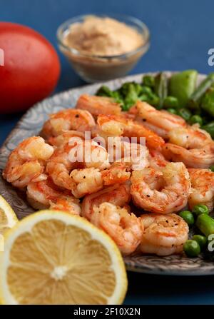 Delicious red king prawns prepared at wok on blue background Stock Photo