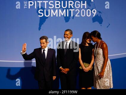 24 September 2009 - Pittsburgh, Pennsylvania - President Barack Obama (2nd L) welcomes French President Nicolas Sarkozy (L) to the welcoming dinner for G-20 leaders at the Phipps Conservatory on September 24, 2009 in Pittsburgh, Pennsylvania as U.S. first lady Michelle Obama (R) and Carla Sarkozy (2nd R) talk with each other. Heads of state from the world's leading economic powers arrived today for the two-day G-20 summit held at the David L. Lawrence Convention Center aimed at promoting economic growth. Photo Credit: Win McNamee/Pool/Sipa Press/0909251406