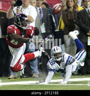 Atlanta Falcons wide receiver Roddy White (84) pulls defender Oakland  Raiders cornerback Michael Huff (24) during