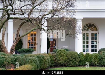 President Donald Trump is seen through the Oval Office door to the West Wing Colonnade of the White House Monday Feb. 10 2020 prior to boarding Marine One to begin his trip to New Hampshire. Stock Photo