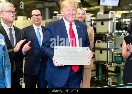President Donald Trump holds up the metal bottom plate of a Mac Pro computer along the assembly line that reads â€œ Mac Pro Designed by Apple in California. Assembled in the USAâ€ as he tours the Apple Manufacturing Plant Wednesday Nov. 20 2019 at Flextronics International LTD-Austin Product Introduction Center. Stock Photo