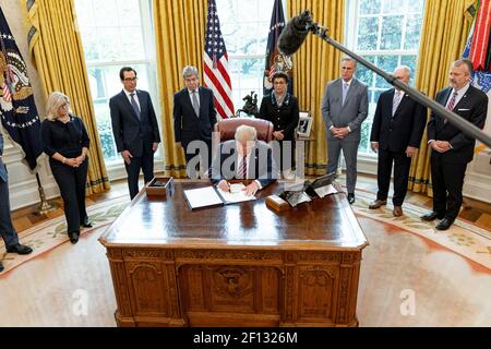 President Donald Trump joined by Vice President Mike Pence Cabinet members and senior legislators signs H.R. 266 â€“ the Paycheck Protection Program and Health Care Enhancement Act Friday April 24 2020 in the Oval Office of the White House. Stock Photo