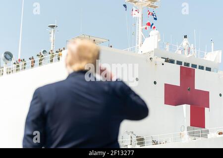 President Donald Trump salutes the USNS Comfort Saturday March 28 2020 as she departs Naval Air Station Norfolk Pier 8 in Norfolk Virginia en route to New York City. Stock Photo