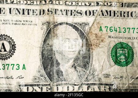 Closeup of the front side of an old wrinkled dirty worn US dollar bill. Stock Photo