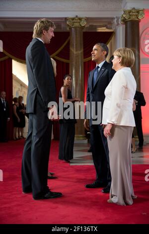 President Barack Obama and German Chancellor Angela Merkel talk with Dallas Mavericks basketball player Dirk Nowitzki before a dinner at Schloss Charlottenburg in Berlin Germany June 19 2013. Stock Photo