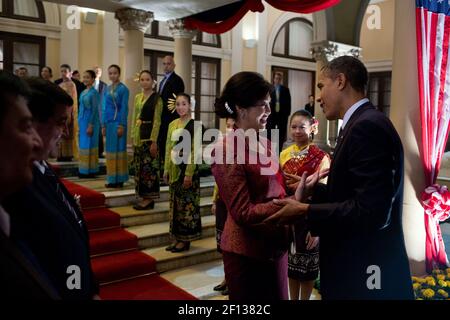 President Barack Obama talks with Thai Prime Minister Yingluck Shinawatra before departing the Government House in Bangkok Thailand Nov. 18 2012. Thai welcome performers line the stairs. Stock Photo