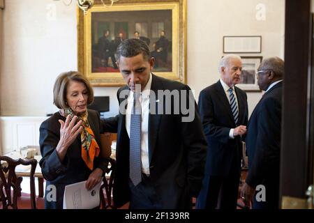 President Barack Obama talks with House Minority Leader Nancy Pelosi D-Calif. as Vice President Joe Biden talks with Rep. James Clyburn D-S.C. after a lunch with the Democratic House leadership in the Oval Office Private Dining Room Feb. 17 2011. Stock Photo
