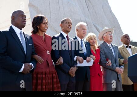 'President Barack Obama First Lady Michelle Obama Vice President Joe Biden and Dr. Jill Biden link arms and sing ''We Shall Overcome'' during the dedication ceremony for the Martin Luther King Jr. National Memorial in Washington D.C. Sunday Oct. 16 2011. Joining them from left are: Harry Johnson Sr.; Interior Secretary Ken Salazar; and Herman ''Skip'' Mason. ' Stock Photo