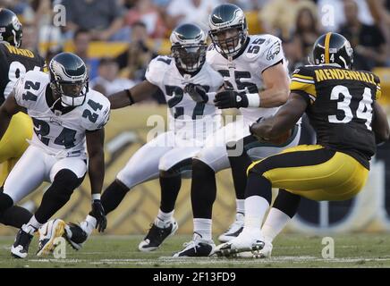 Philadelphia Eagles Joselio Hanson (21) and Stewart Bradley (55) celebrate  an interception by teammate Quintin Mikell (27) against the New York Giants  in the fourth quarter of an NFC Divisional Playoff game.