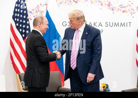 President Donald Trump welcomes President of the Russian Federation Vladimir Putin as he arrives to attend their bilateral meeting during the G20 Japan Summit Friday June 28 2019 in Osaka Japan. Stock Photo