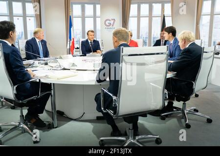 President Donald Trump joins G7 Leaders Italian Prime Minister Giuseppe Conte; European Council President Donald Tusk; Japan Prime Minister Shinzo Abe; United Kingdom Prime Minister Boris Johnson; German Chancellor Angela Merkel; Canadian Prime Minister Justin Trudeau and G7 Summit host French President Emmanuel Macron during a G7 Working Session on Global Economy Foreign Policy and Security Affairs at the Centre de CongrÃ©s Bellevue Sunday Aug. 25 2019 in Biarritz France. Stock Photo