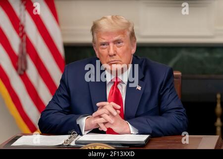 President Donald Trump speaks with armed services personnel Thursday Nov. 26 2020 during a Thanksgiving video teleconference call from the Diplomatic Reception Room of the White House. Stock Photo