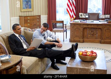 President Barack Obama works on his State of the Union address with Director of Speechwriting Jon Favreau in the Oval Office, Jan. 24, 2011 Stock Photo