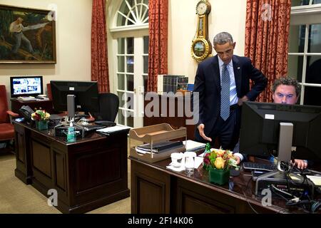 President Barack Obama works on a press statement with Director of Speechwriting Cody Keenan in the Outer Oval Office, Nov. 24, 2014 Stock Photo