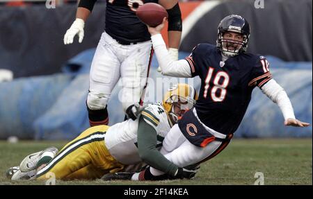 Chicago Bears quarterback Kyle Orton (18) gets up as Green Bay Packers'  Justin Harrell (91), Aaron Kampman (74) and Charles Woodson (21) celebrate  an incomplete pass during the second half of an