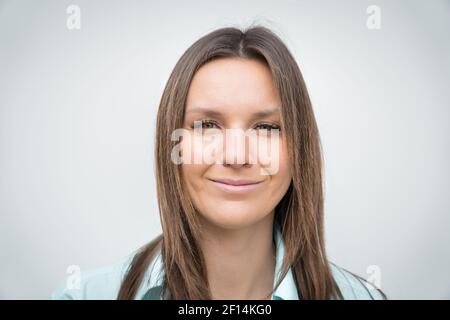 Close up portrait of young cheerful happy business woman with beautiful smile looking at the camera Stock Photo